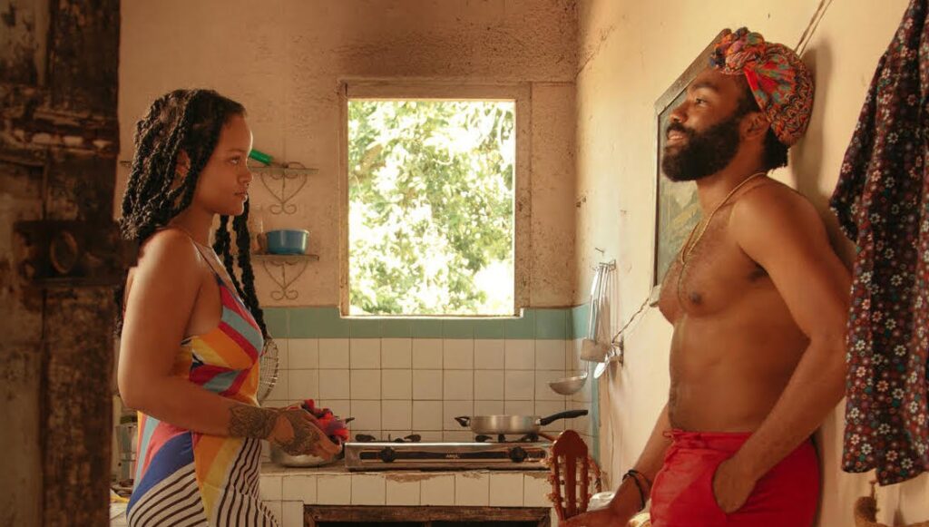 Rihanna and Donald Glover in Guava Island, directed by Hiro Murai. Tropical, colorful film scene.