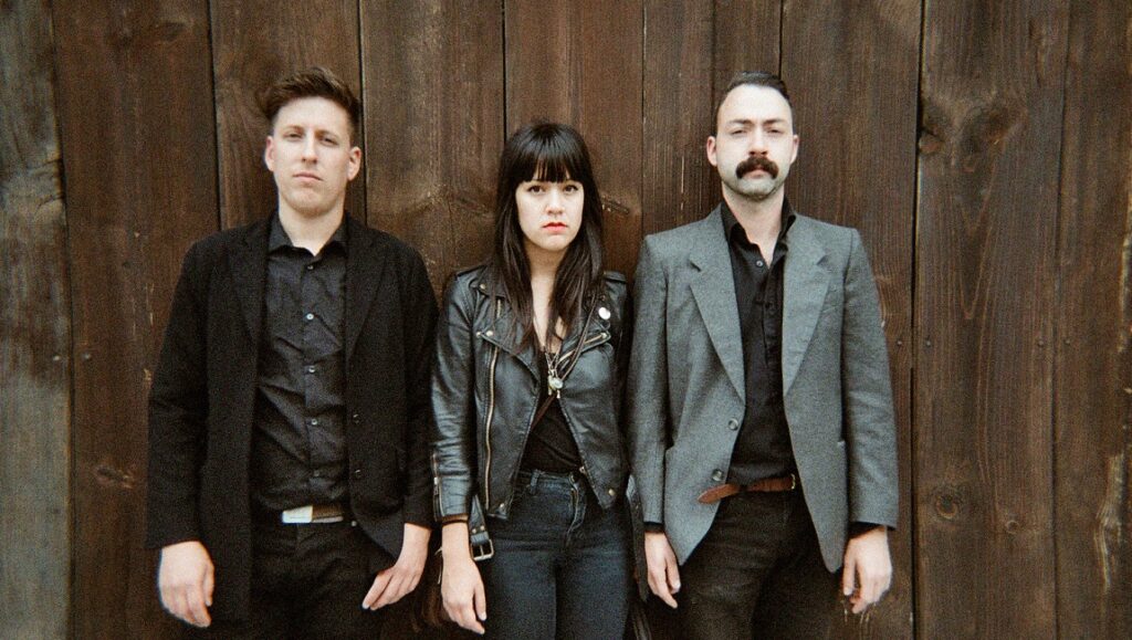 BIG|BRAVE | A Gaze Among Them BIG|BRAVE band photo. Band members of A Gaze Among Them album, standing against a wood background.