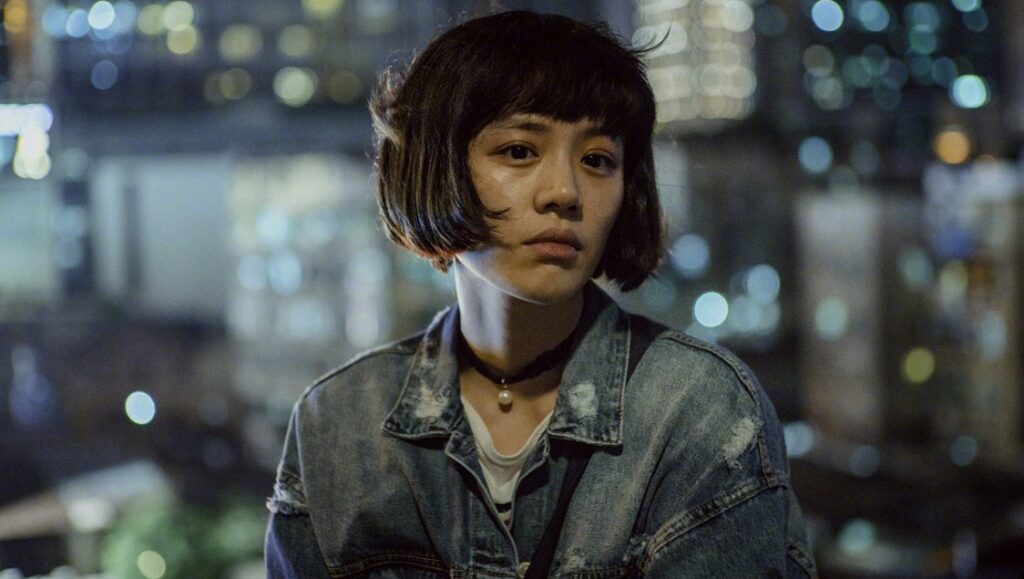 The Shadow Play | Lou Ye Lou Ye film Shadowplay still. Actress with short bob haircut and denim jacket. Retrospective film series.