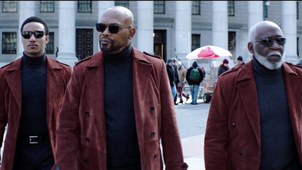 Shaft movie image: Samuel L. Jackson, Jessie Usher, and Richard Roundtree in burgundy coats and sunglasses.