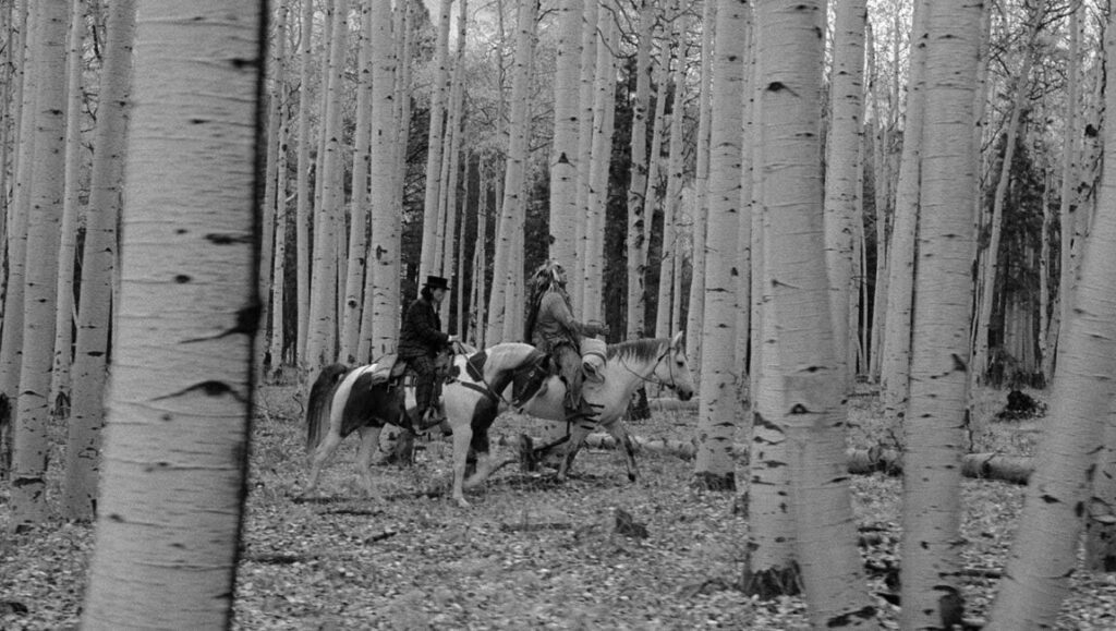 Dead Man | Jim Jarmusch Dead Man film still: Johnny Depp and Nobody ride horses through a forest of birch trees. Black and white.