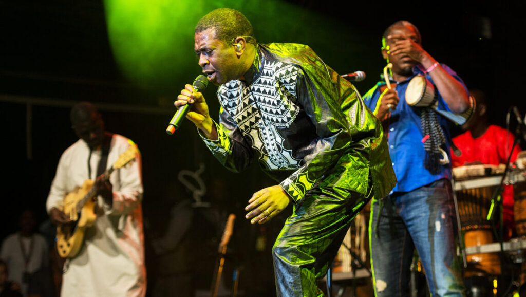 Youssou N'Dour performs live in 2013. The Senegalese singer is on stage with his band. Foreign Correspondent | Issue 4.