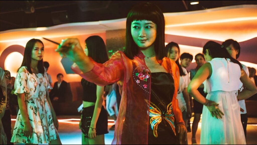 Ash film still from 2019's top films. Woman in a club with a wand.