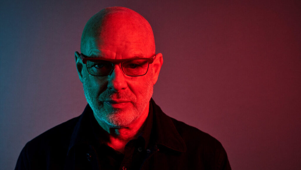 Brian Eno | Apollo: Atmospheres and Soundtracks Brian Eno, Apollo: Atmospheres and Soundtracks. Portrait of Eno wearing glasses, illuminated with red and blue light.