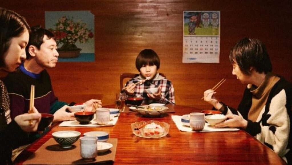 Jesus film scene: Family at dinner table with chopsticks. Hiroshi Okuyama movie still.