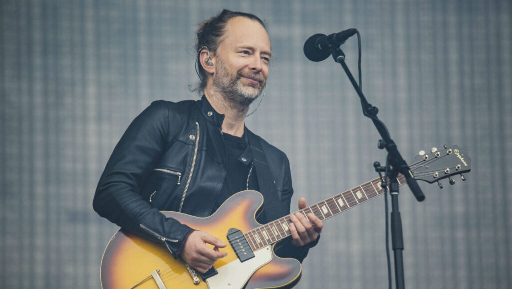 Thom Yorke, of Radiohead, performing live. Yorke's solo album is Anima. He plays guitar and sings.