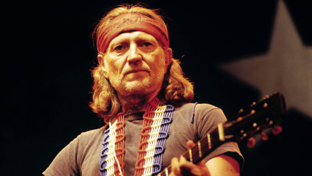 Willie Nelson, Red Headed Stranger era. Country music icon with guitar and signature bandana.