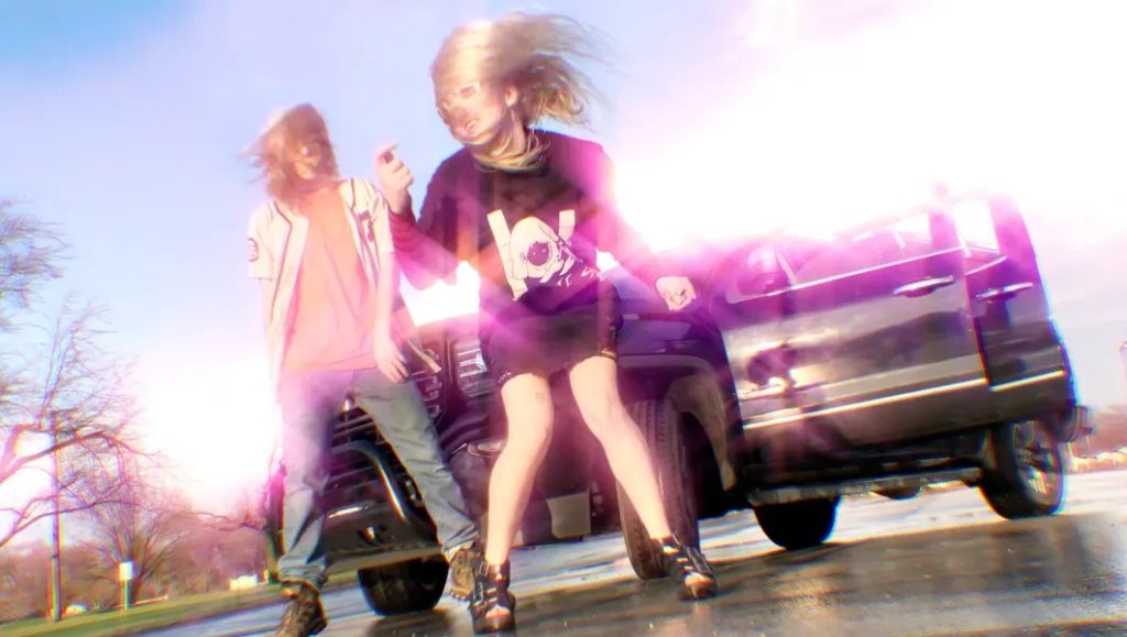 100 Gecs | 1000 Gecs 100 Gecs 1000 Gecs album art. Dylan Brady and Laura Les stand in front of a black SUV. Hyperpop music duo.