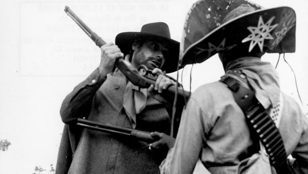 Black God, White Devil film still. Glauber Rocha film featuring armed men in hats.