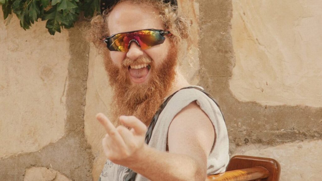 Cecil Frena | Pit Boss Cecil Frena, Pit Boss. Man with red beard, sunglasses, smiling, and gesturing.