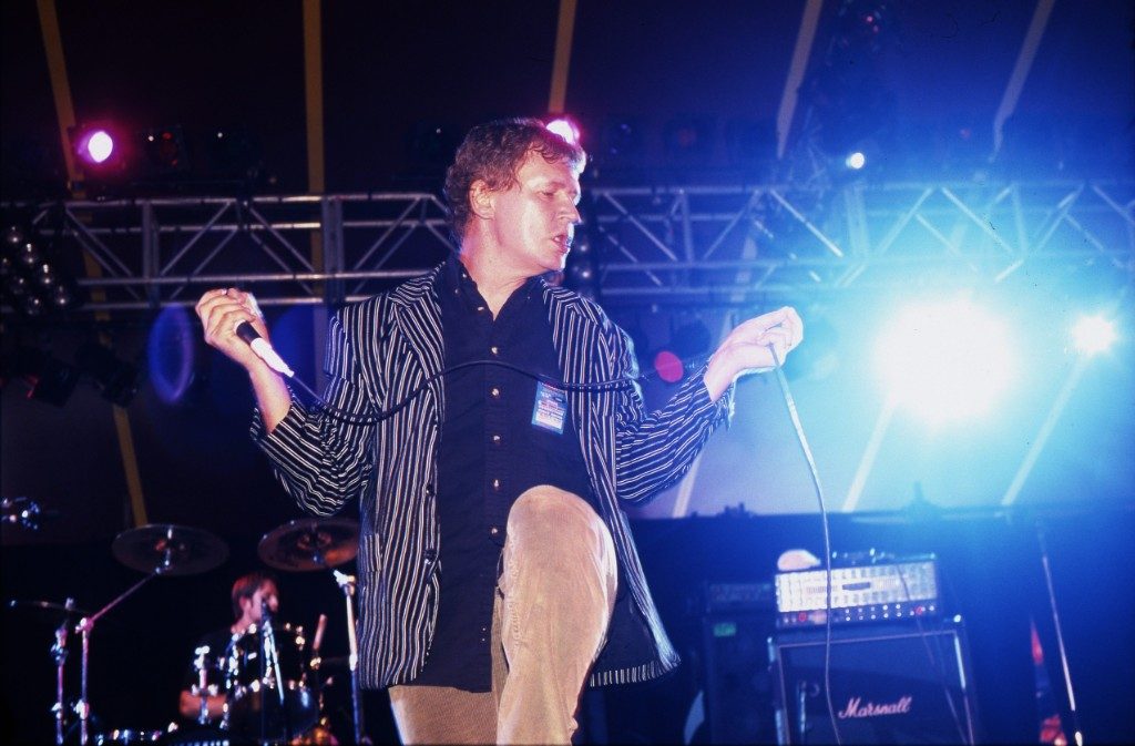 Guided By Voices | Bee Thousand Guided By Voices live. Robert Pollard performing Bee Thousand era indie rock music on stage with a microphone.