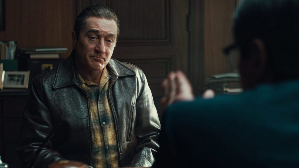 Robert De Niro in The Irishman, a Martin Scorsese film. Leather jacket, plaid shirt.