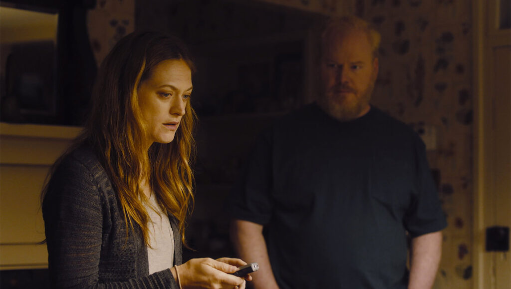 Light From Light | Paul Harrill Light From Light movie still. Woman holds device, man stands behind. Paul Harrill film.