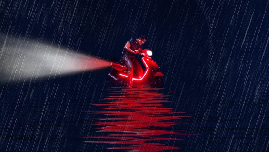 The Wild Goose Lake film still: Man on red scooter in the rain. Portland International Film Festival 2020.