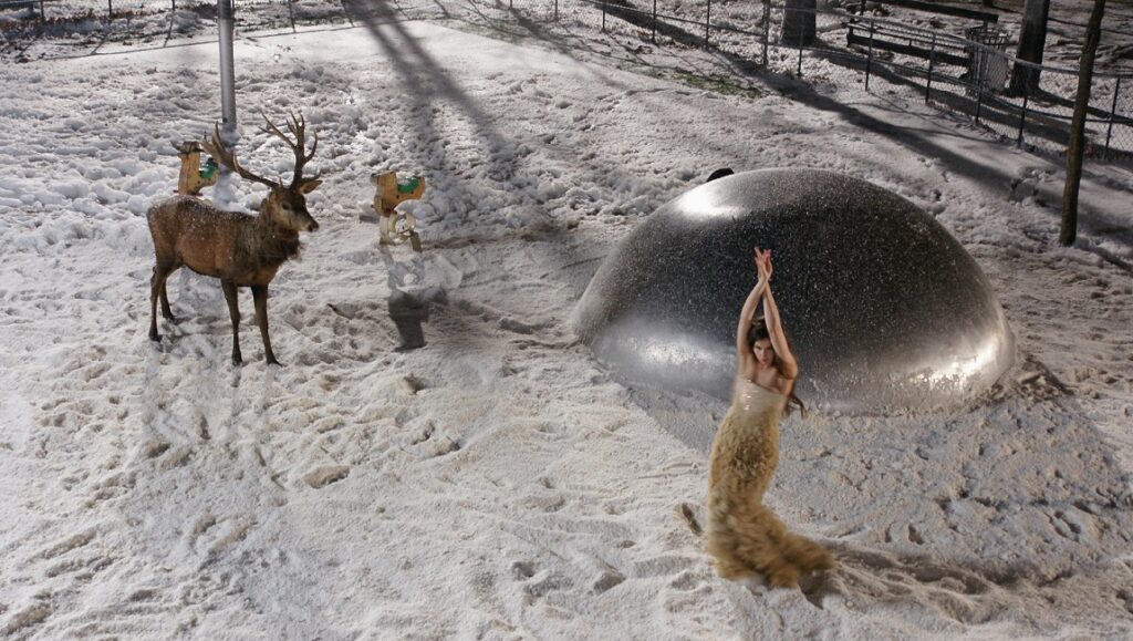 Face | Tsai Ming-liang Journey to the West scene: Woman in gown, deer, and dome in snowy landscape. Tsai Ming-liang film.