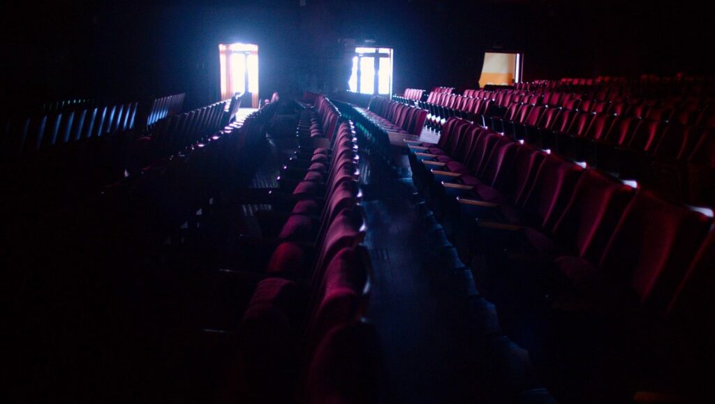 Light | Tsai Ming-liang Empty theater seats in the dark, lit by light from doorways. Tsai Ming-liang Light series.