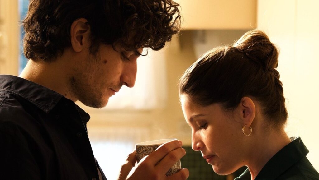 A Faithful Man | Louis Garrel Louis Garrel in A Faithful Man. Man holds a steaming cup near a woman. Relationship drama.