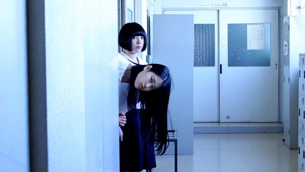 Amiko | Yoko Yamanaka Yoko Yamanaka's Amiko film still. Two young women in a hallway. Japanese cinema.