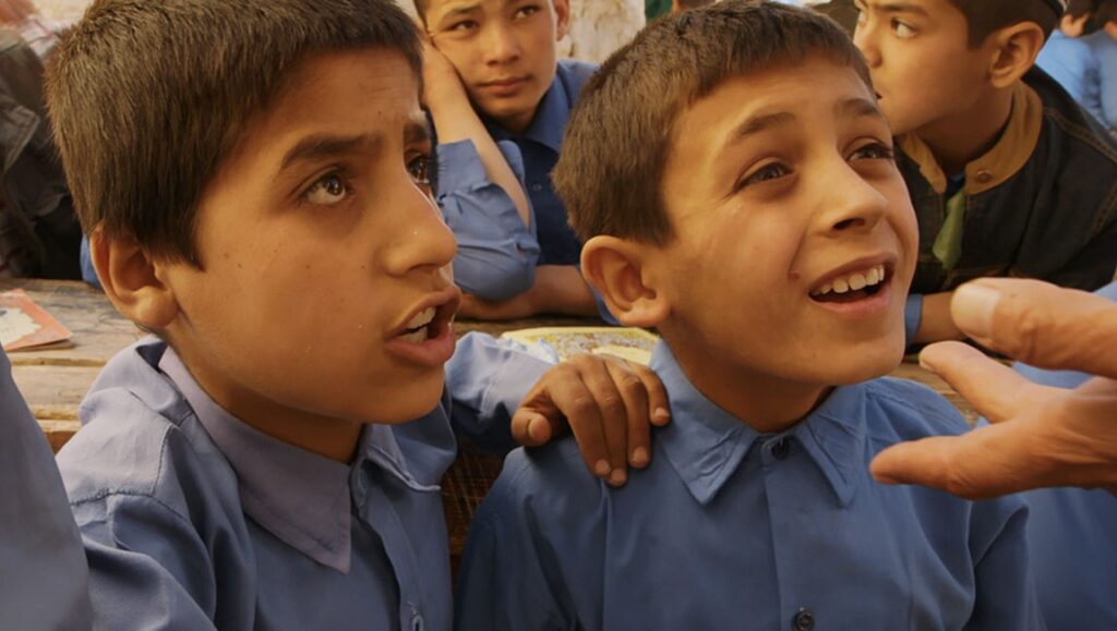 Angels Are Made of Light | James Longley Angels Are Made of Light: Afghan schoolboys in blue uniforms listening attentively. James Longley film.