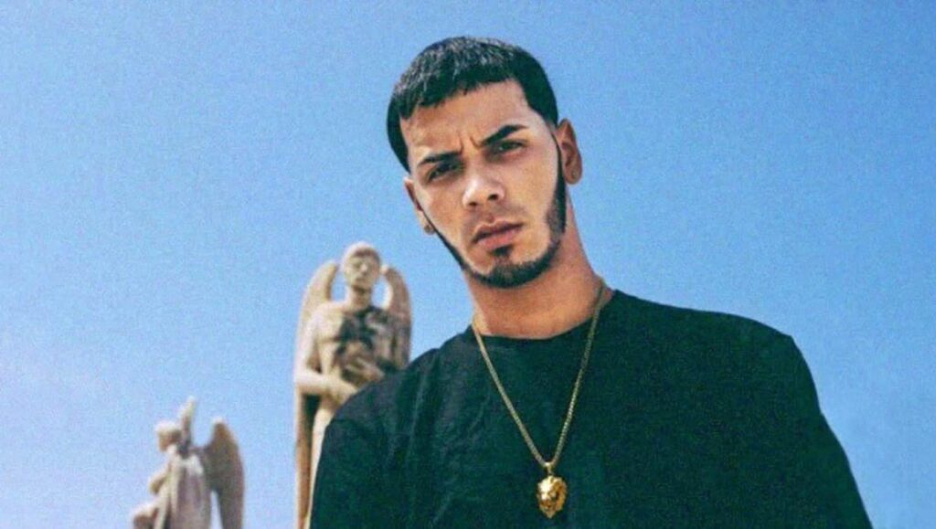 Anuel AA | Real Hasta la Muerte Anuel AA. Care for Me album art. Rapper with a gold chain and angel statues.