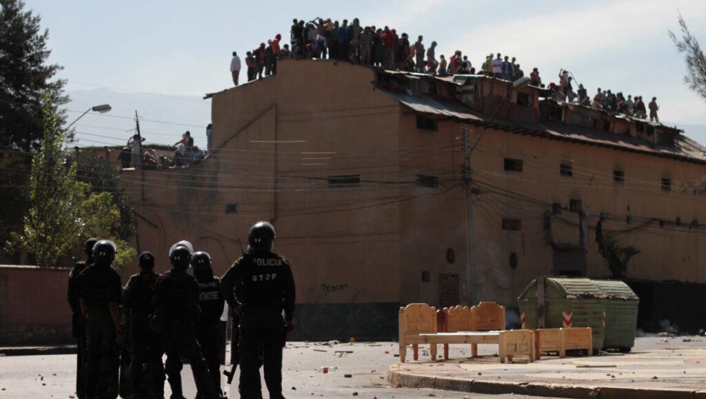 Cocaine Prison | Violeta Ayala Scene from Cocaine Prison documentary. Crowd on roof, police in riot gear below.