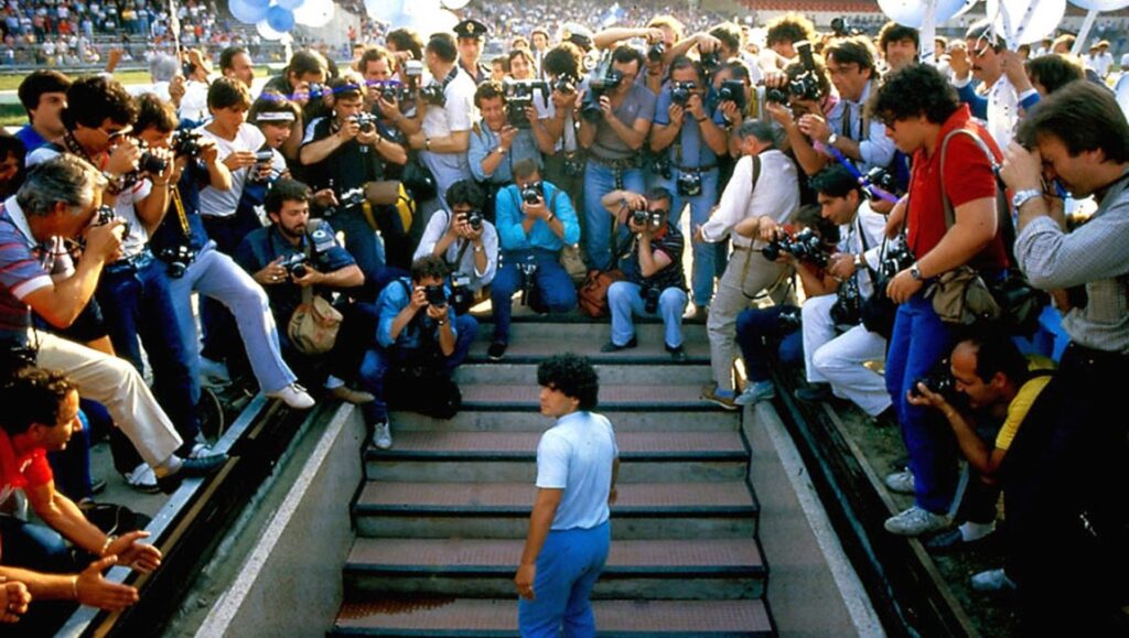 Diego Maradona surrounded by photographers. Asif Kapadia film about the football legend.