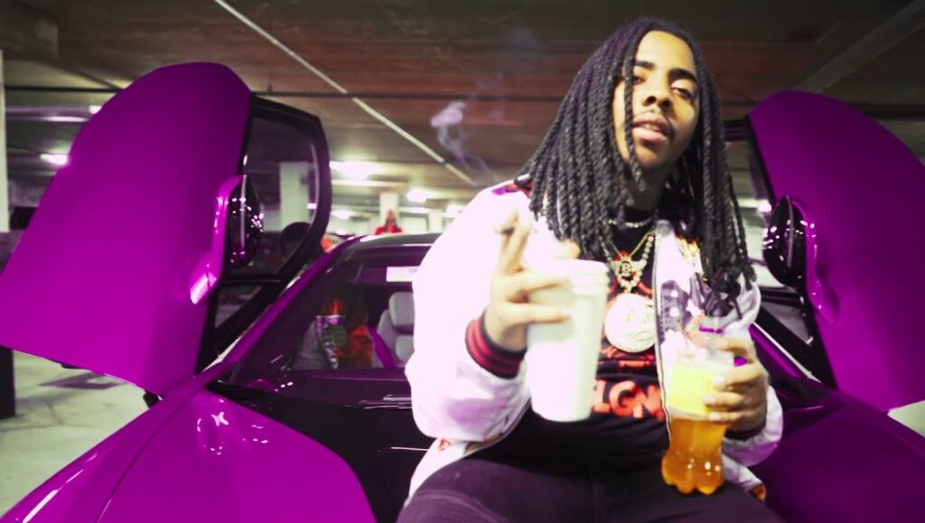 DooWop | Cappin’ Aint Dead DooWop, rapper, with purple car. Cappin' Ain't Dead music video.