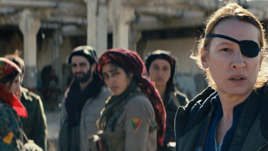 Girls of the Sun | Eva Husson Girls of the Sun movie scene. Kurdish female fighters in war-torn area, one with eye patch. Eva Husson film.