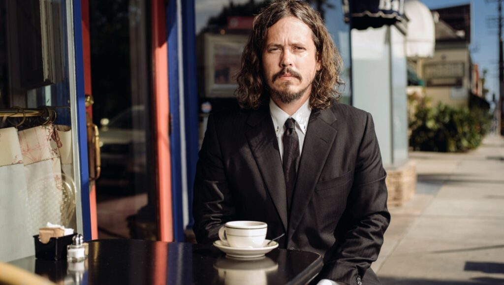 John Paul White | The Hurting Kind John Paul White, *The Hurting Kind*. Musician in a suit at an outdoor cafe with coffee. Album art.