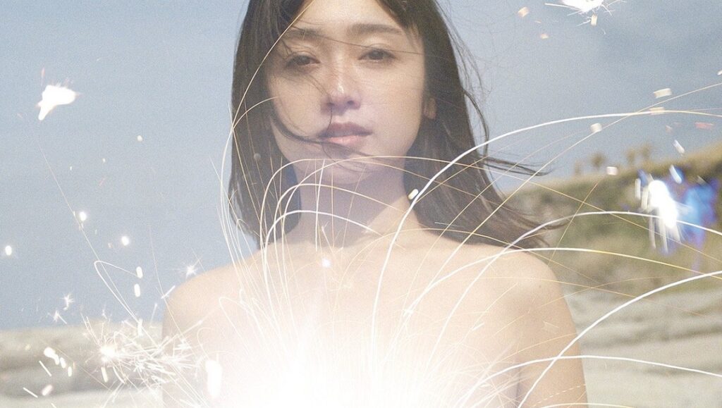 Kayoko Yoshizawa| Jyoyuu Shimai Kayoko Yoshizawa, Jyoyuu Shimai. Portrait of the Japanese actress with sparklers on a beach.