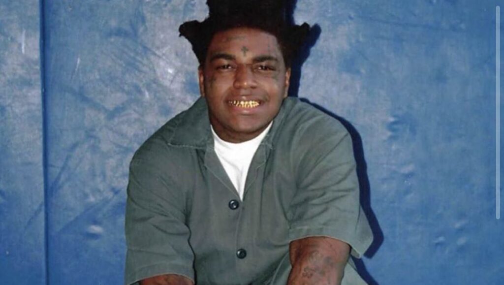 Kodak Black | Dying to Live Kodak Black in Dying to Live era. Rapper with gold teeth, prison uniform, and tattoos.