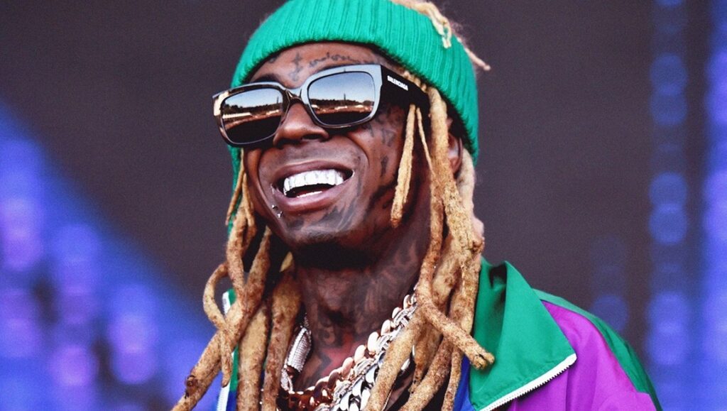 What Would Meek Do? | Q2 2020 Issue – Part 2: Lil Wayne, DaBaby, Eminem Lil Wayne Q2 2020. Rapper Lil Wayne wearing sunglasses and a green beanie. He is wearing a chain and smiling.