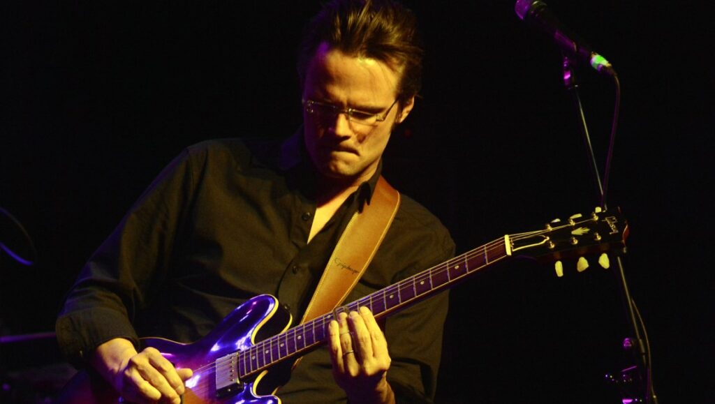 Luther Dickinson | Solstice Luther Dickinson performing live. Guitarist playing music on stage. Solstice album.