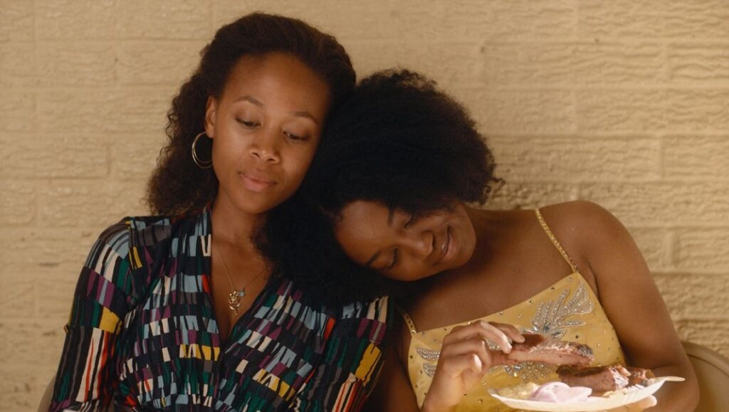 Miss Juneteenth | Channing Godfrey Peoples Miss Juneteenth film still: Mother and daughter share a quiet moment, enjoying food together.