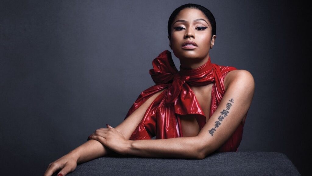 Nicki Minaj, Queen album era. Rapper in red with tattoo.