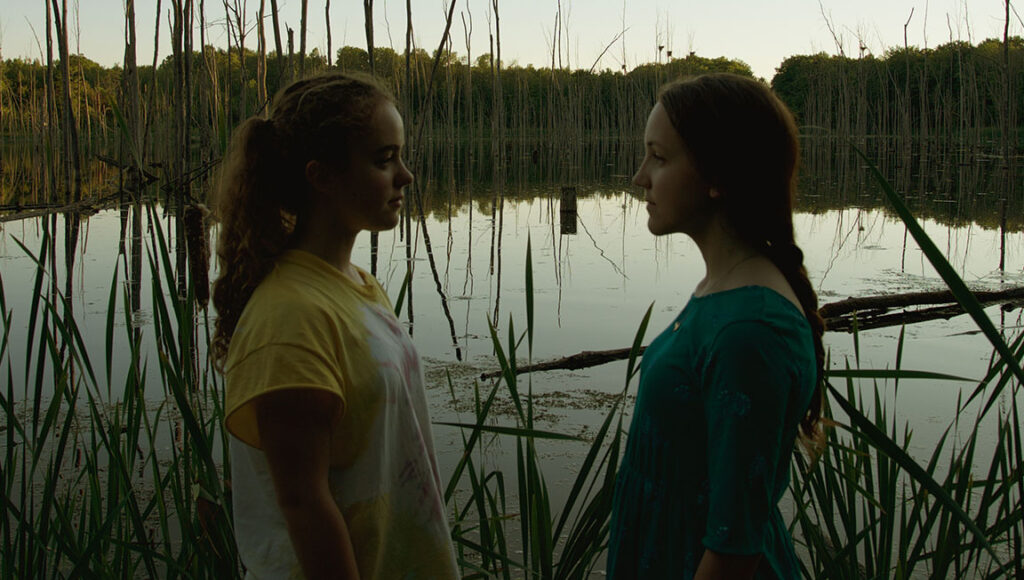 Porcupine Lake | Ingrid Veninger Two girls face each other at Porcupine Lake, an Ingrid Veninger film. Nature, friendship, and drama.