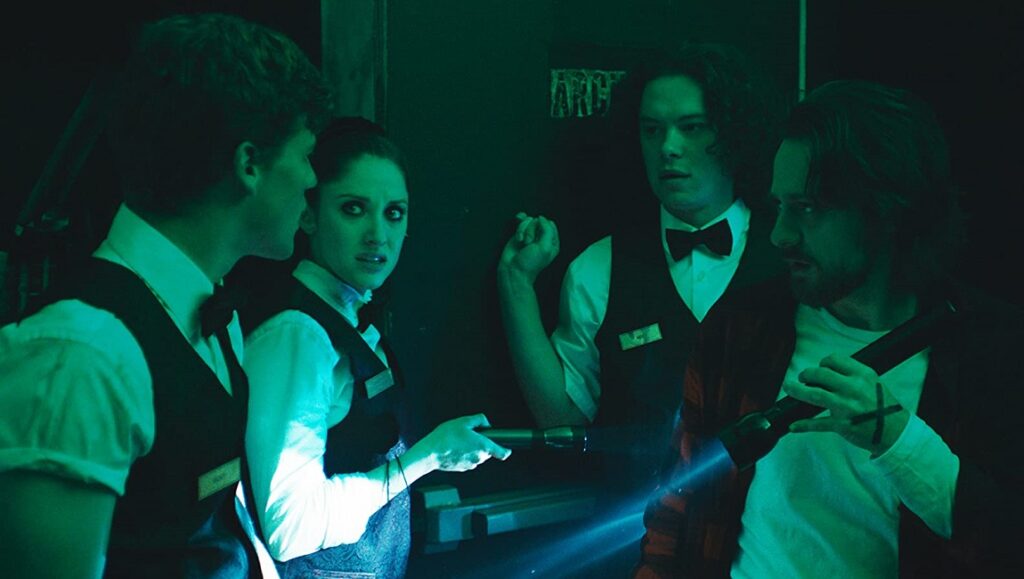 Porno | Keola Racela Keola Racela's Porno film still. Cast members with flashlights in a dark room.