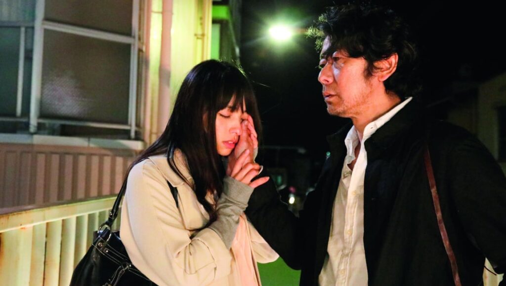 Radiance film scene: A man comforts a crying woman. Naomi Kawase film.