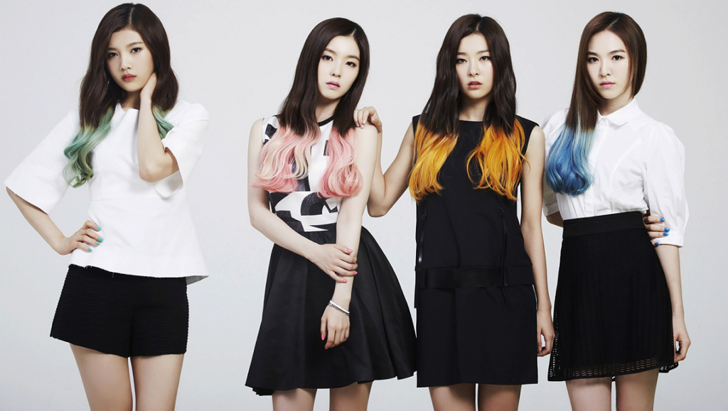 Red Velvet RBB era promotional image. K-pop group with colorful hair stands together in black and white outfits.