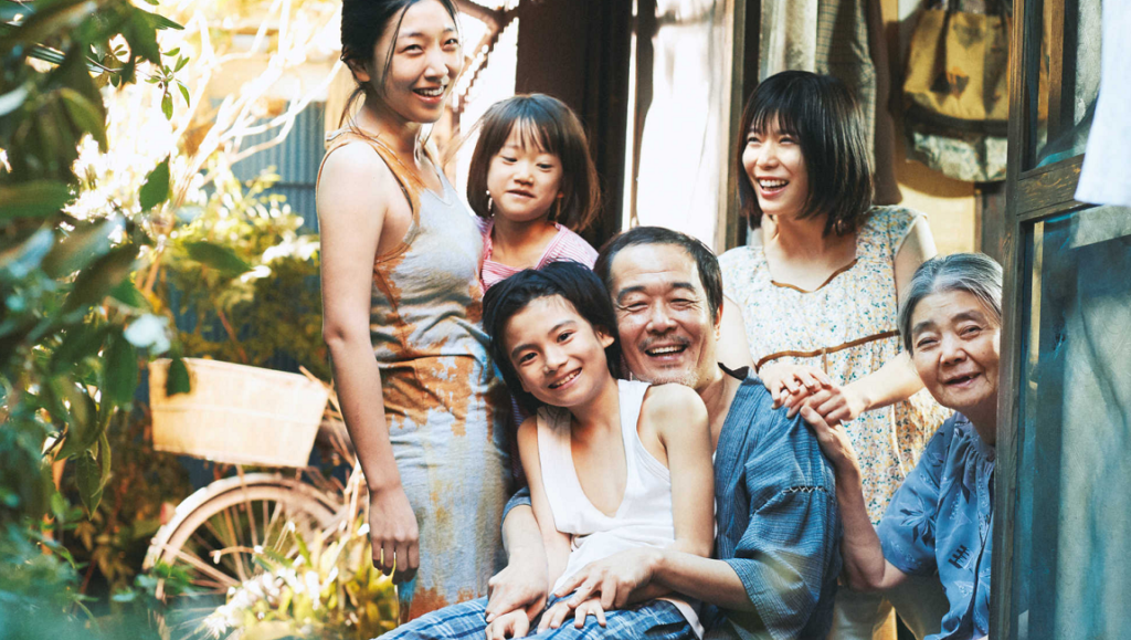 Shoplifters film cast. A smiling, close-knit Japanese family of six. Hirokazu Kore-eda movie.