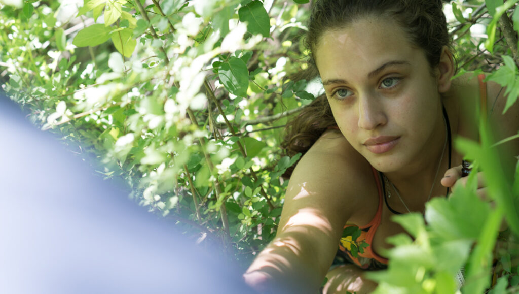 The Sleepwalkers movie still: Paula Hernandez film featuring a young woman outdoors in lush greenery.