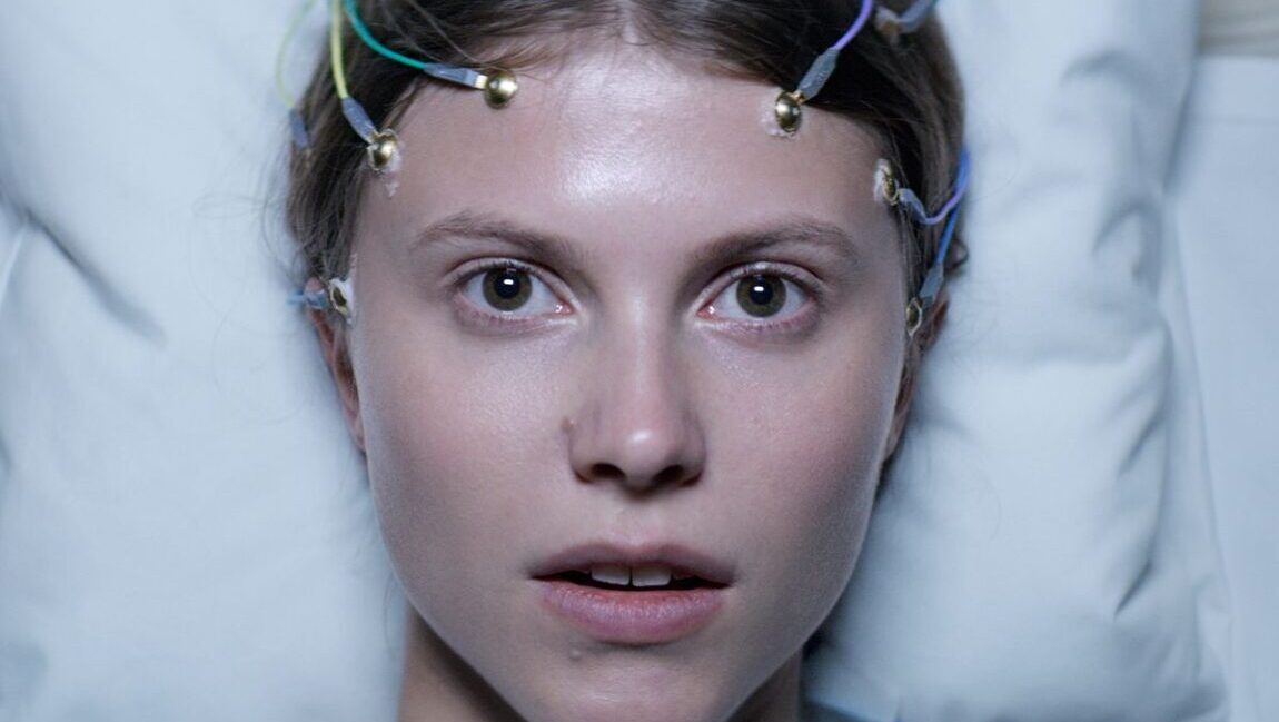 Close-up of Thelma, a Joachim Trier film. Actress with EEG electrodes on her head. Psychological thriller.