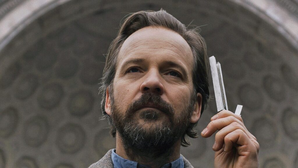The Sound of Silence | Michael Tyburski Peter Sarsgaard in The Sound of Silence movie. Sarsgaard holds tuning forks, analyzing sound.