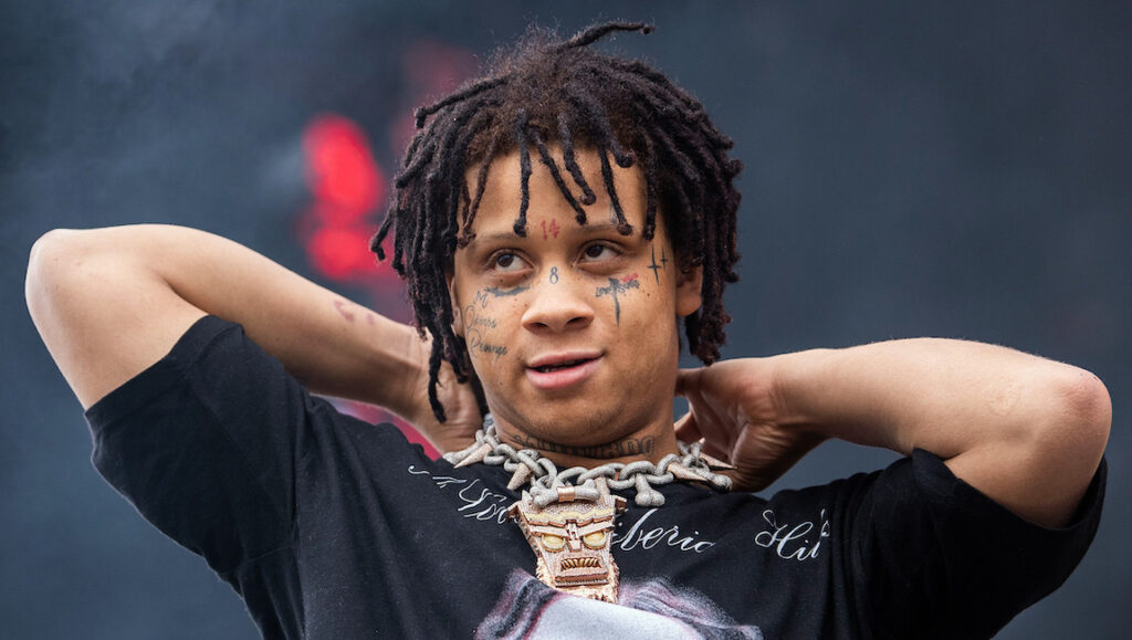 Trippie Redd | Life’s a Trip Trippie Redd, Life's a Trip era. Rapper with dreadlocks, face tattoos, and a large chain.