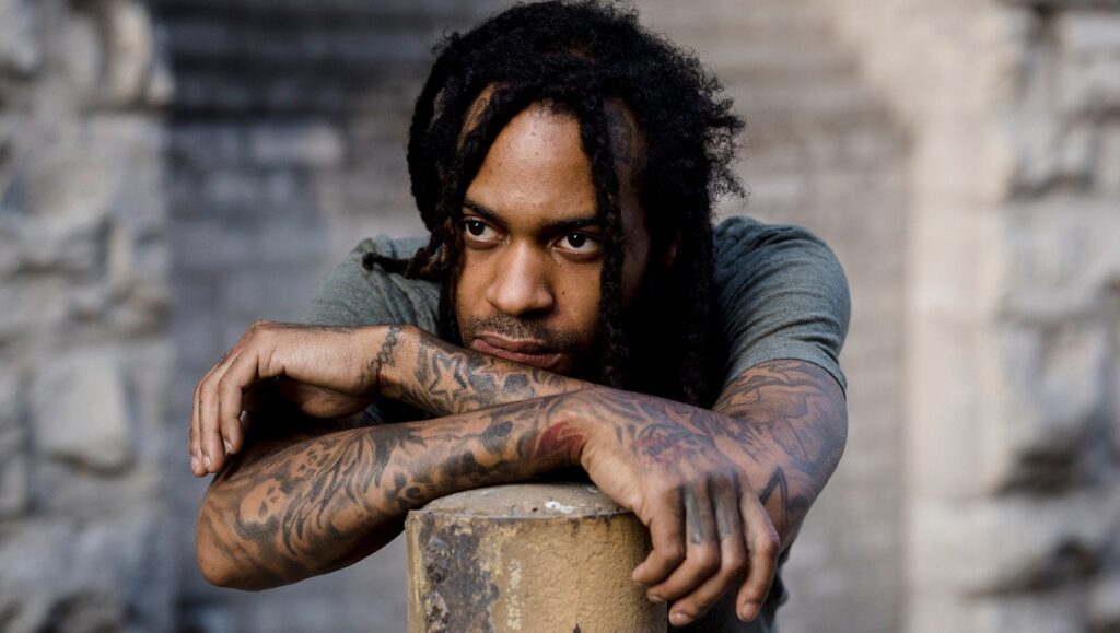 Valee | GOOD Job, You Found Me Saba, Care for Me album art. Portrait of the rapper with dreadlocks and tattoos.