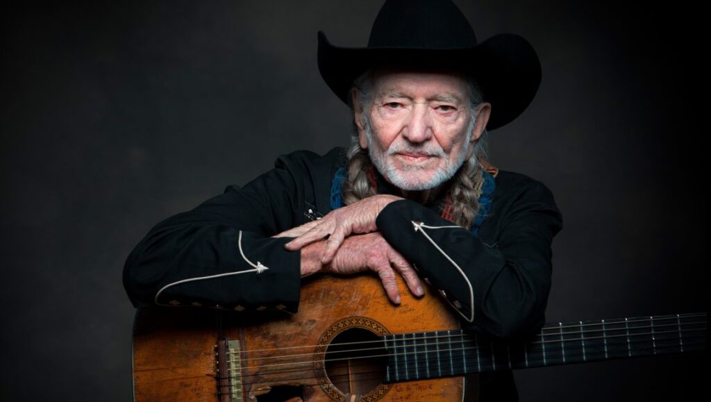 Willie Nelson | Ride Me Back Home Willie Nelson with guitar. Ride Me Back Home album cover. Country music icon.