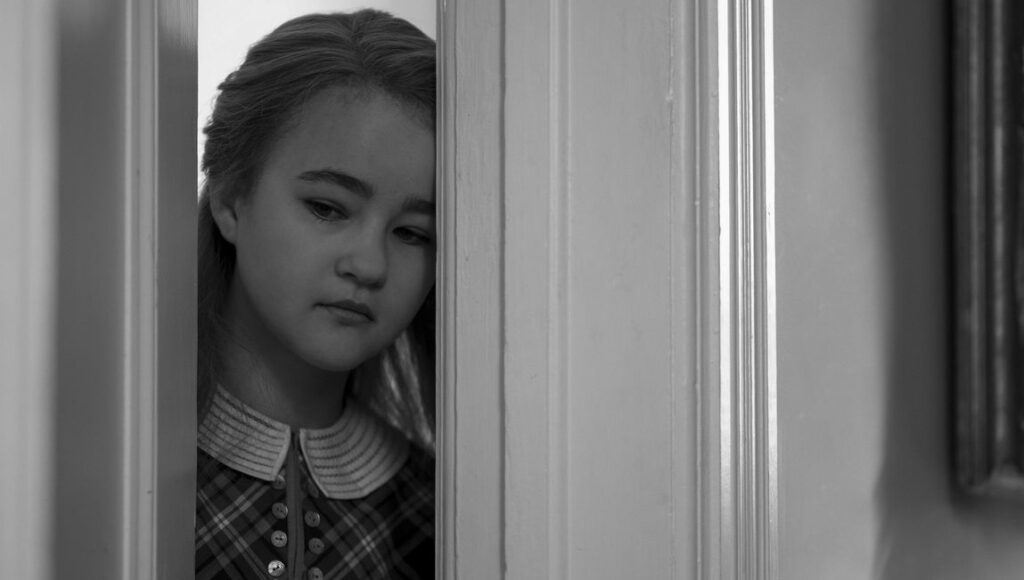 Wonderstruck | Todd Haynes Black and white still from Wonderstruck film. Young girl peers from behind a door. Todd Haynes movie.