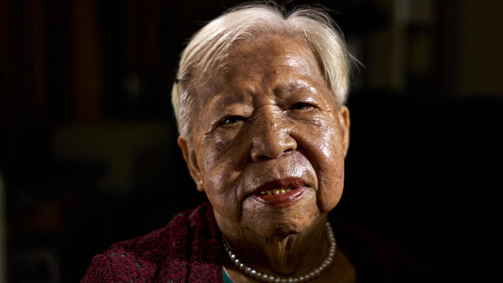 Your Face | Tsai Ming-liang Close-up of elderly woman's face from Tsai Ming-liang's Your Face film. Pearls, short white hair.