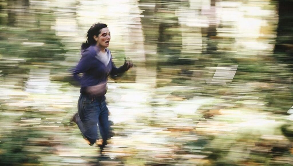 Fantasia Fest 2020 – Dispatch 3: Alone, Dinner in America, Detention Alone movie still from Fantasia Fest 2020. Woman running in forest, motion blur. Thriller, horror film.