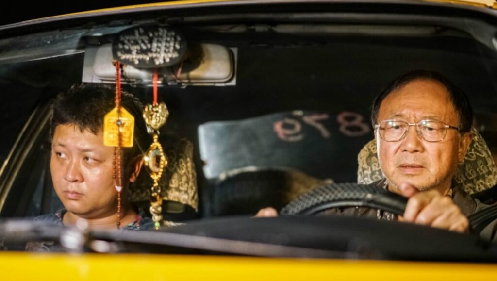 Godspeed film scene: Two men in a taxi. Chung Mong-hong directs this Taiwanese crime drama.